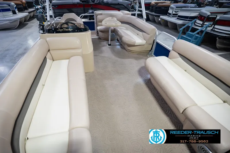 Slide: The Image of 2014 Sun Tracker Party Barge 20 DLX interior with beige seating in showroom. - 13