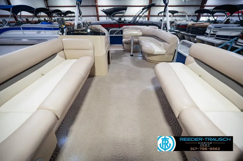 Slide: The Image of 2014 Sun Tracker Party Barge 20 DLX interior with beige seating and spacious layout. - 16