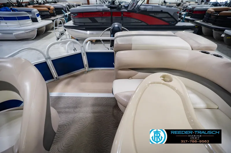 Slide: The Image of 2014 Sun Tracker Party Barge 20 DLX interior with beige seating and blue accents. - 18