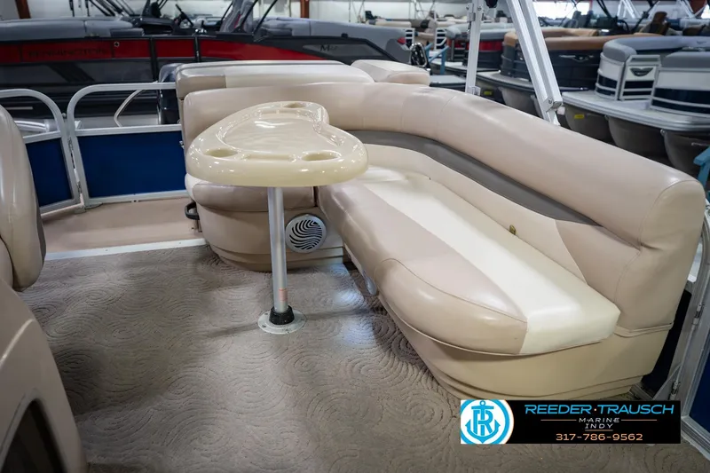 Slide: The Image of 2014 Sun Tracker Party Barge 20 DLX interior with beige seating and table. - 23