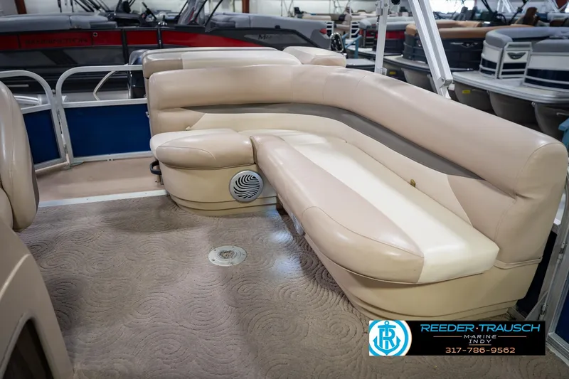 Slide: The Image of 2014 Sun Tracker Party Barge 20 DLX interior with beige seating and carpeted floor. - 24