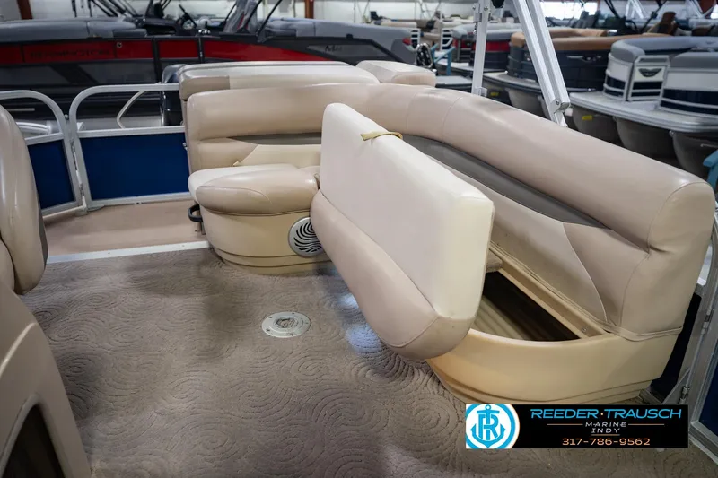 Slide: The Image of 2014 Sun Tracker Party Barge 20 DLX interior with beige seating and storage compartment. - 25