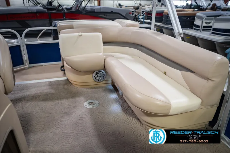 Slide: The Image of 2014 Sun Tracker Party Barge 20 DLX interior with beige seating and carpeted floor. - 26