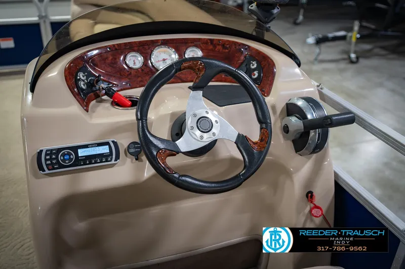 Slide: The Image of 2014 Sun Tracker Party Barge 20 DLX steering console with controls and gauges. - 28