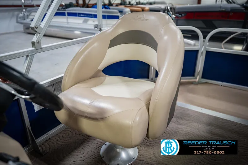Slide: The Image of 2014 Sun Tracker Party Barge 20 DLX captain's chair in a showroom setting. - 36