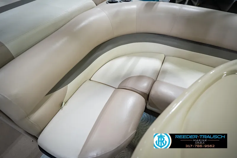Slide: The Image of 2014 Sun Tracker Party Barge 20 DLX interior seating with beige upholstery and cup holders. - 39