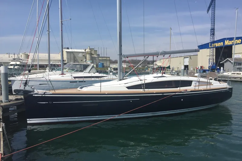 The Image of 2017 Jeanneau Sun Odyssey 41 DS sailboat docked at marina, clear sky background. - 0