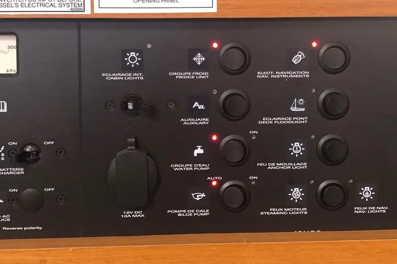 Slide: The Image of Control panel of a 2017 Jeanneau Sun Odyssey 41 DS yacht, featuring various switches and indicators. - 10