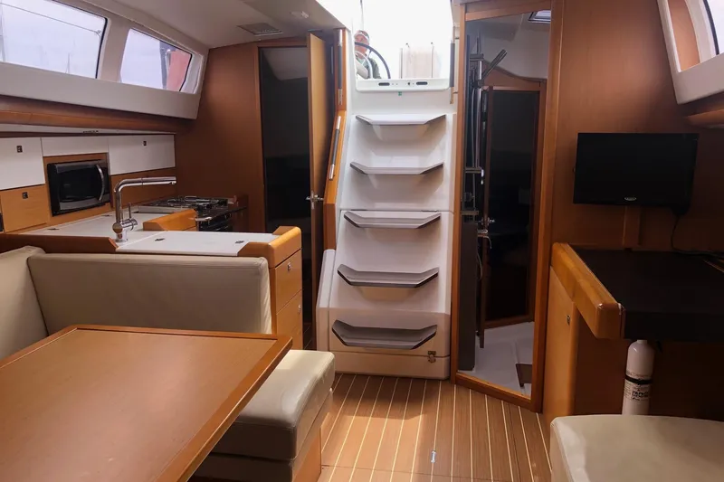 Slide: The Image of Interior of 2017 Jeanneau Sun Odyssey 41 DS yacht, featuring kitchen and seating area. - 17
