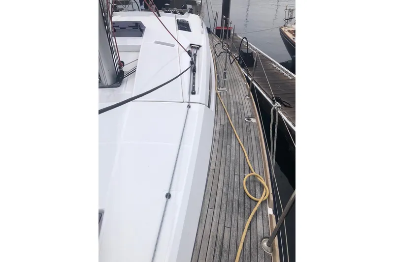 Slide: The Image of 2017 Jeanneau Sun Odyssey 41 DS yacht docked, showcasing sleek deck design and mooring lines. - 21