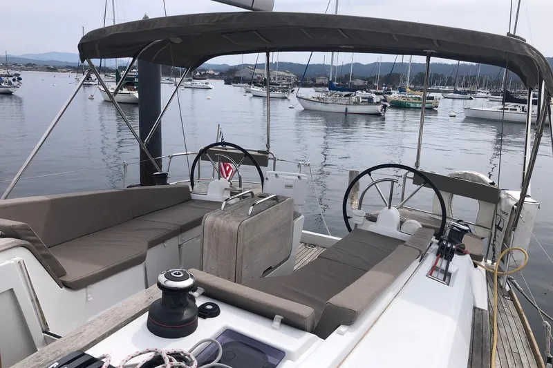 Slide: The Image of 2017 Jeanneau Sun Odyssey 41 DS sailboat cockpit with dual steering wheels in a marina. - 29