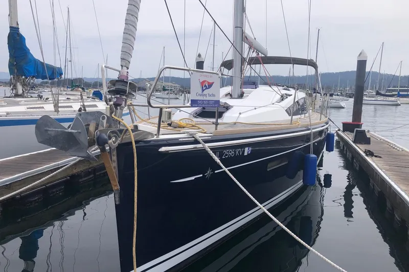 Slide: The Image of 2017 Jeanneau Sun Odyssey 41 DS sailboat docked in a marina, featuring sleek design and blue hull. - 3