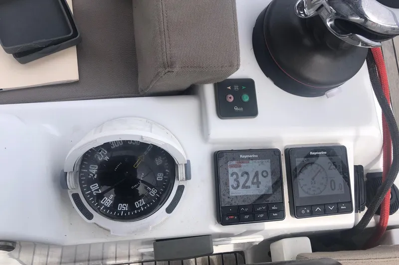 Slide: The Image of Cockpit instruments of 2017 Jeanneau Sun Odyssey 41 DS, featuring compass and Raymarine displays. - 32