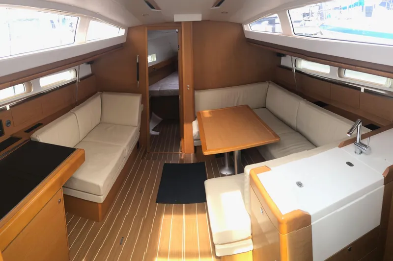 Slide: The Image of Interior of 2017 Jeanneau Sun Odyssey 41 DS yacht with cozy seating and wooden finishes. - 5