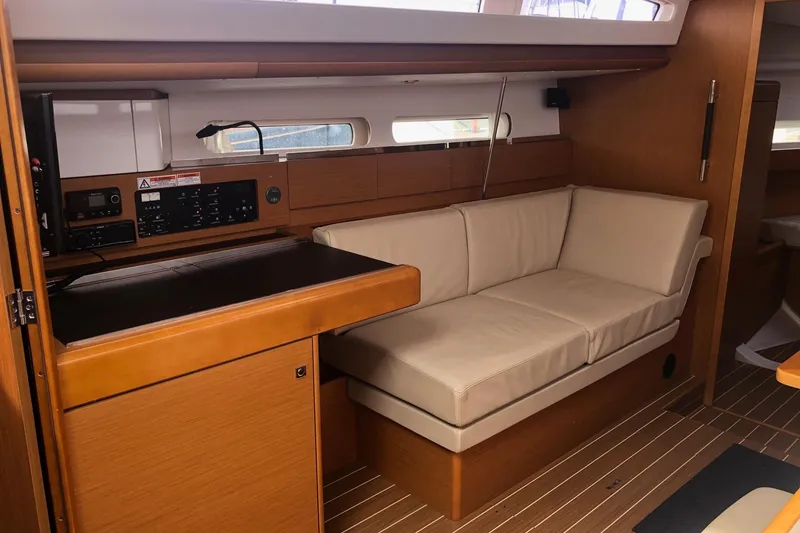 Slide: The Image of Interior of 2017 Jeanneau Sun Odyssey 41 DS with beige seating and navigation station. - 7