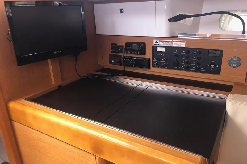 Slide: The Image of Navigation station of 2017 Jeanneau Sun Odyssey 41 DS with control panel and TV. - 8