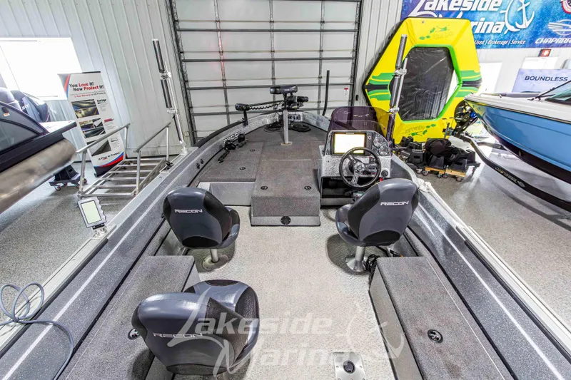 Slide: The Image of 2019 Recon 2185 SC boat interior with steering console and seating at Lakeside Marina showroom. - 14