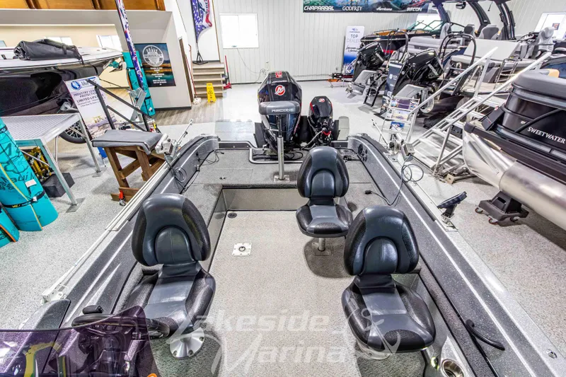 Slide: The Image of 2019 Recon 2185 SC boat interior with four seats, displayed in a showroom. - 15