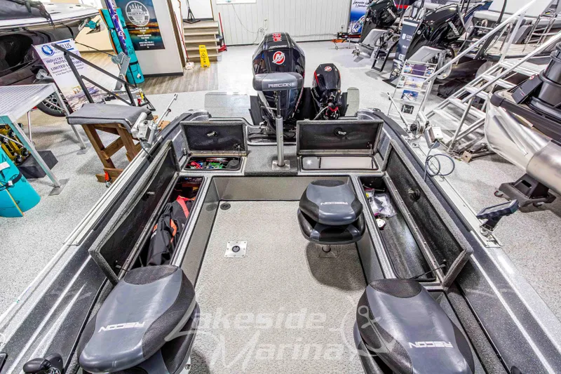 Slide: The Image of 2019 Recon 2185 SC boat interior with storage compartments and seating at Lakeside Marina. - 16