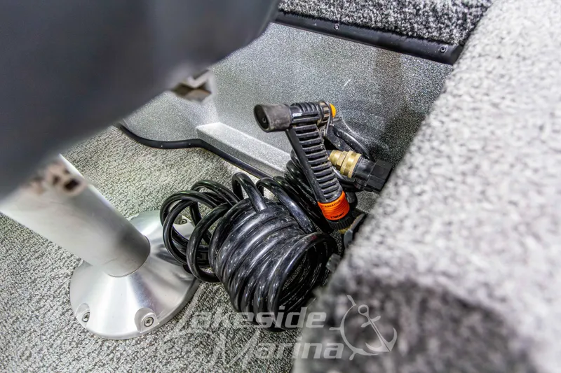 Slide: The Image of Coiled hose and fittings in a 2019 Recon 2185 SC boat interior. - 19