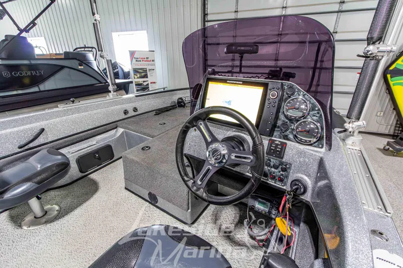 Slide: The Image of Interior of a 2019 Recon 2185 SC boat with steering wheel and control panel. - 20