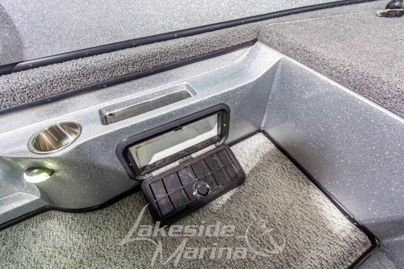 Slide: The Image of Interior of 2019 Recon 2185 SC boat with storage compartment and cup holder. - 25