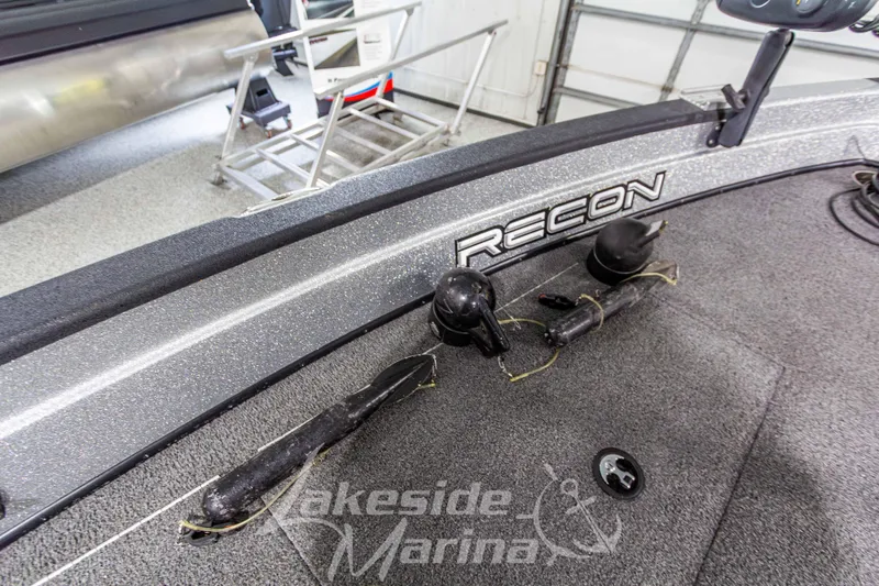 Slide: The Image of 2019 Recon 2185 SC boat interior with fishing rod holders at Lakeside Marina. - 27