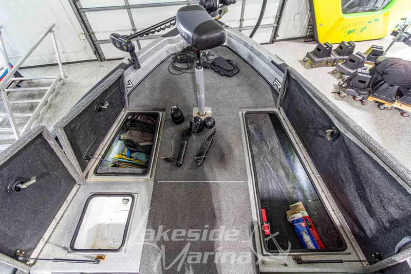 Slide: The Image of 2019 Recon 2185 SC boat interior with storage compartments and fishing gear. - 29