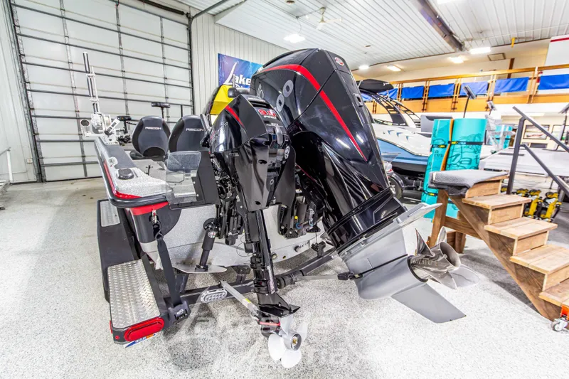 Slide: The Image of 2019 Recon 2185 SC boat with powerful outboard motor in showroom setting. - 3