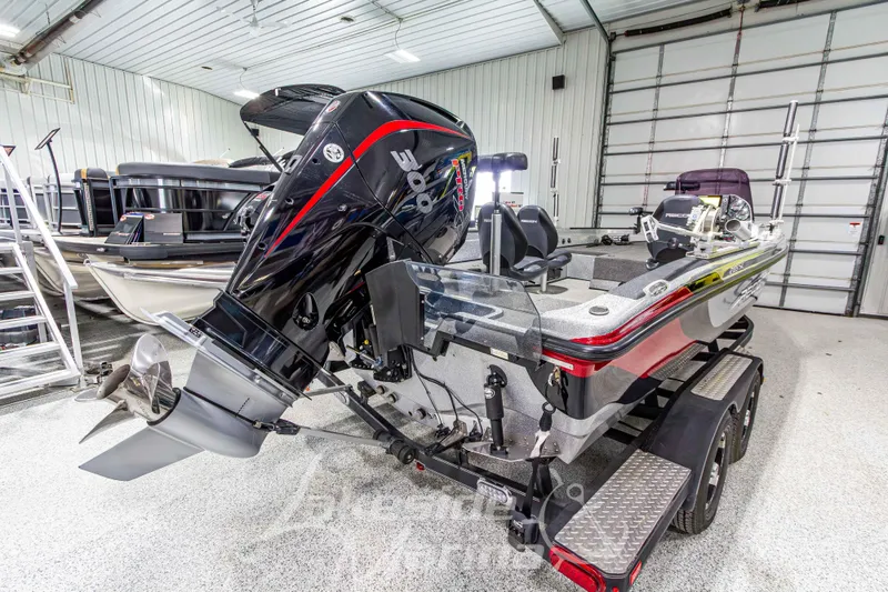 Slide: The Image of 2019 Recon 2185 SC boat with powerful outboard motor in a spacious garage. - 5