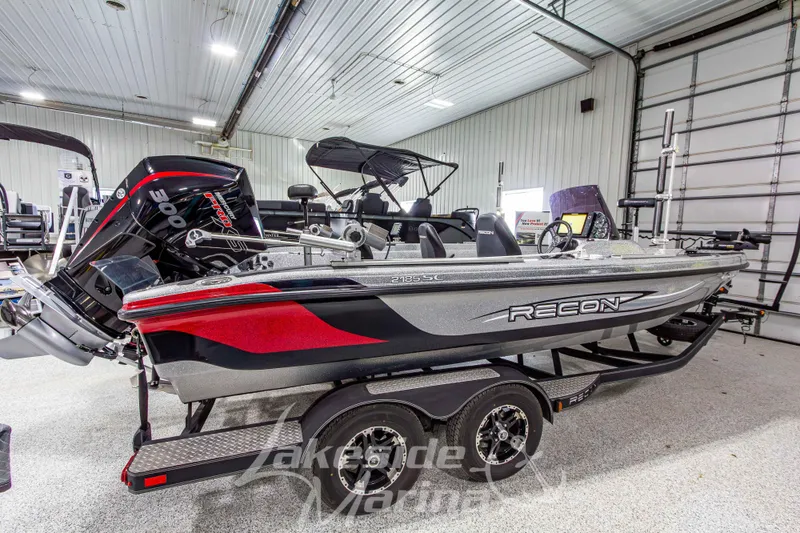 Slide: The Image of 2019 Recon 2185 SC boat in showroom, featuring sleek design and powerful engine. - 6