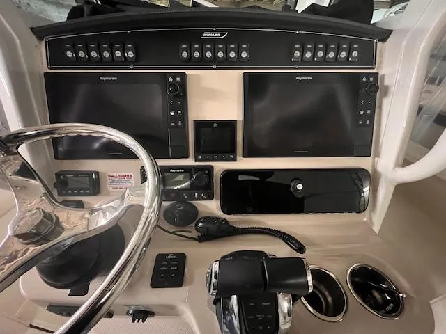 Slide: The Image of 2022 Boston Whaler 250 Outrage dashboard with advanced navigation controls. - 5