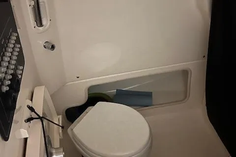 Slide: The Image of Interior of 2022 Boston Whaler 250 Outrage boat bathroom with toilet. - 7