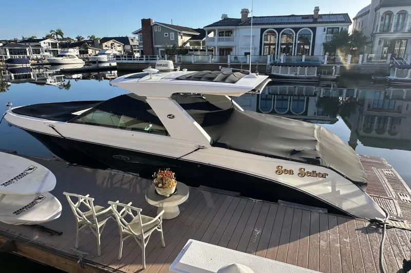 The Image of 2018 Sea Ray SLX 400 boat docked in a serene waterfront setting. - 0