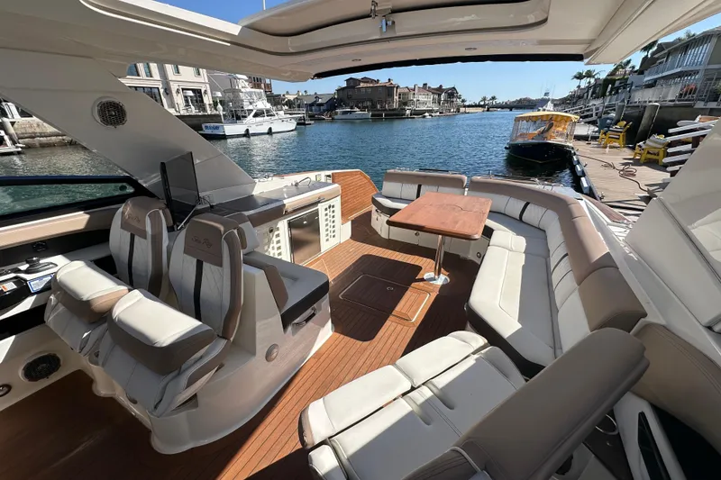 Slide: The Image of Luxurious 2018 Sea Ray SLX 400 boat interior with plush seating and waterfront view. - 10