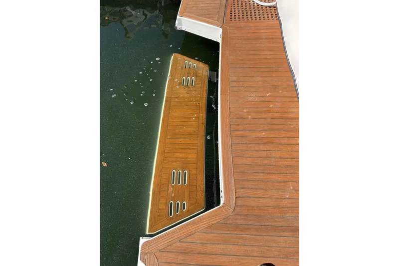 Slide: The Image of 2018 Sea Ray SLX 400 swim platform with teak decking, partially submerged in water. - 12