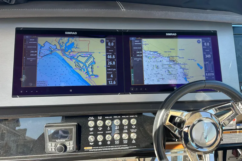 Slide: The Image of Dashboard of a 2018 Sea Ray SLX 400 with dual Simrad navigation screens. - 14