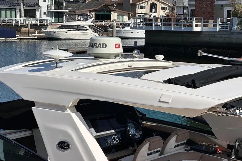 Slide: The Image of 2018 Sea Ray SLX 400 yacht docked in a marina, featuring advanced navigation equipment. - 15