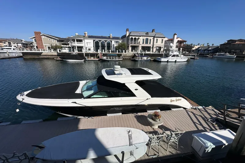Slide: The Image of 2018 Sea Ray SLX 400 yacht docked in a scenic marina setting. - 20