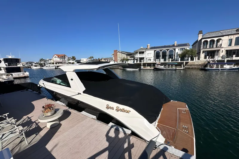 Slide: The Image of 2018 Sea Ray SLX 400 docked in a scenic waterfront marina. - 21