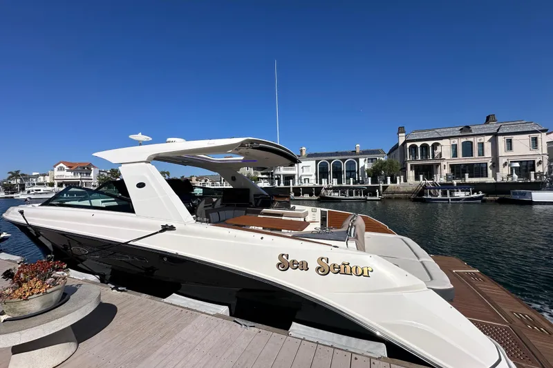 Slide: The Image of 2018 Sea Ray SLX 400 yacht docked in a luxurious waterfront setting. - 24