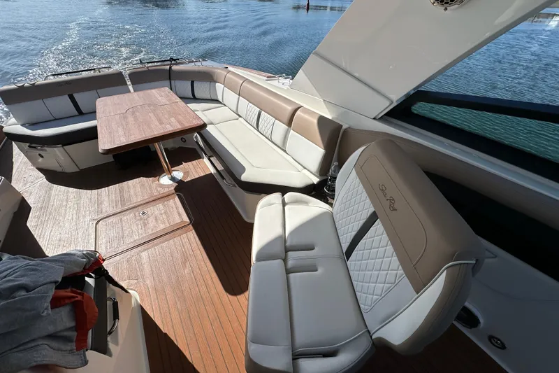 Slide: The Image of Luxurious seating area on a 2018 Sea Ray SLX 400 boat with elegant wood table. - 26