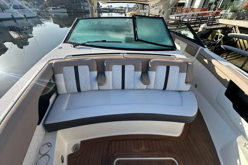 Slide: The Image of 2018 Sea Ray SLX 400 boat interior with cushioned seating and waterfront view. - 29