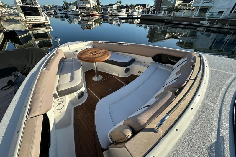 Slide: The Image of Luxurious 2018 Sea Ray SLX 400 boat interior with elegant seating and wooden table. - 30