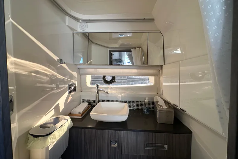 Slide: The Image of Luxurious bathroom interior of 2018 Sea Ray SLX 400 yacht with modern sink and mirror. - 32