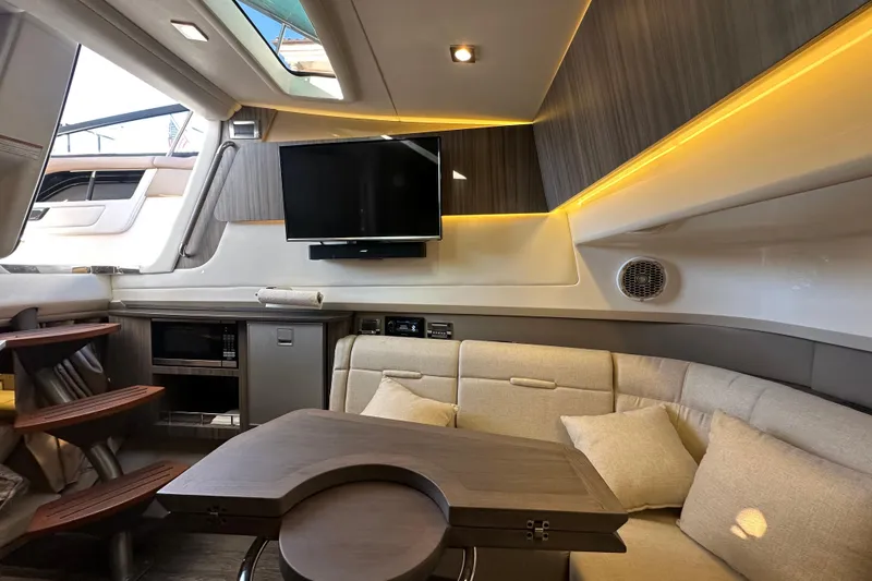 Slide: The Image of Luxurious interior of 2018 Sea Ray SLX 400 yacht with seating, TV, and ambient lighting. - 33