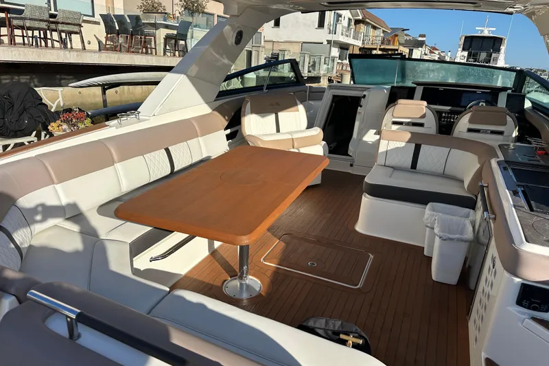 Slide: The Image of Luxurious 2018 Sea Ray SLX 400 yacht interior with elegant seating and wooden table. - 35
