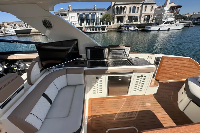 Slide: The Image of Luxurious 2018 Sea Ray SLX 400 yacht interior with seating, grill, and waterfront view. - 5
