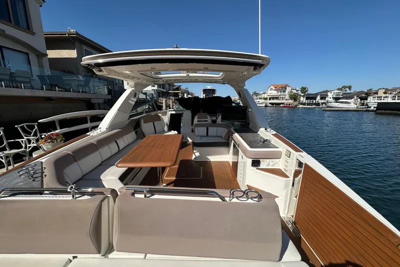 Slide: The Image of 2018 Sea Ray SLX 400 boat with spacious deck and seating, docked in a marina. - 6