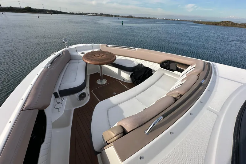 Slide: The Image of 2018 Sea Ray SLX 400 boat with spacious seating and table on calm water. - 7